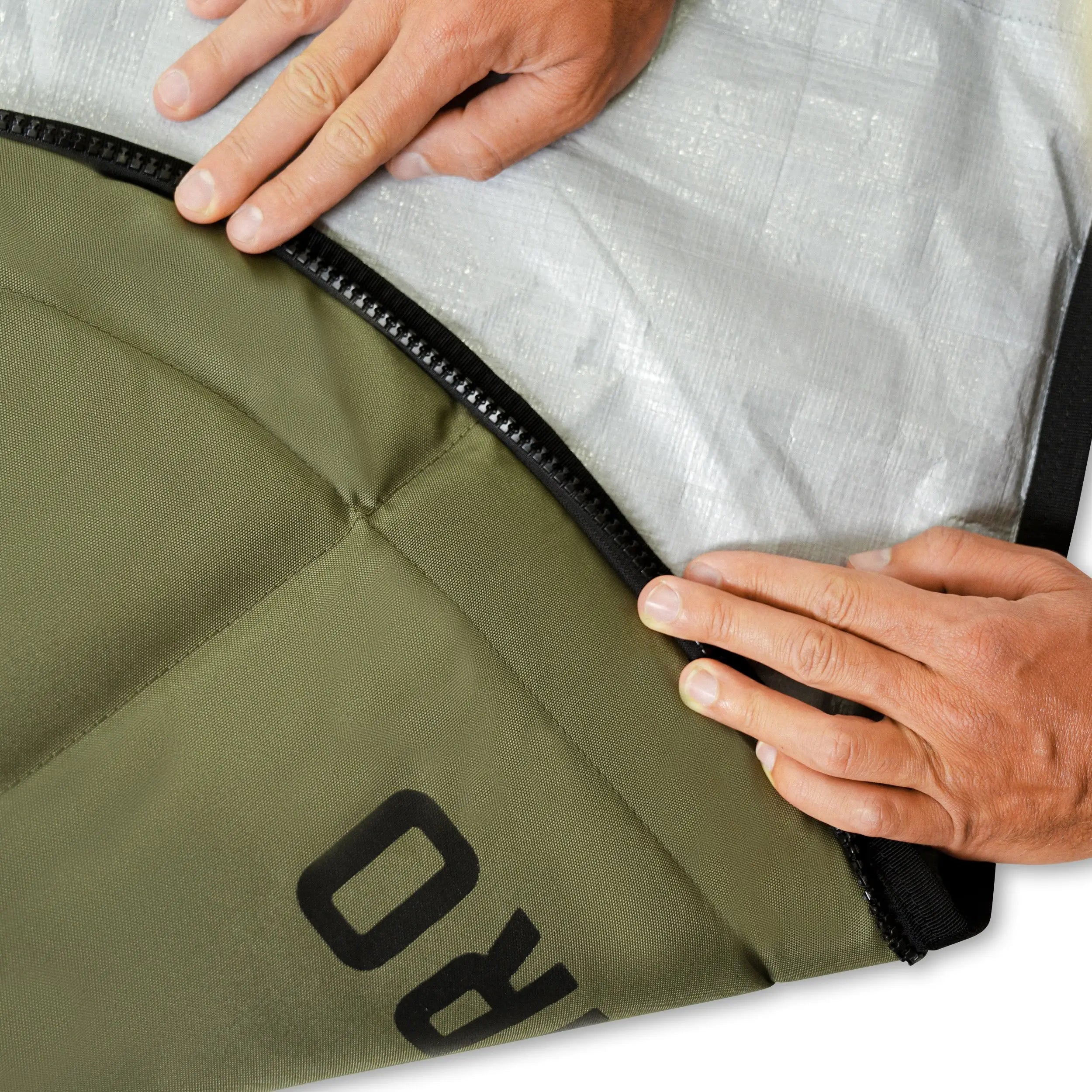 Person opening a green bag with a brand logo on a white background