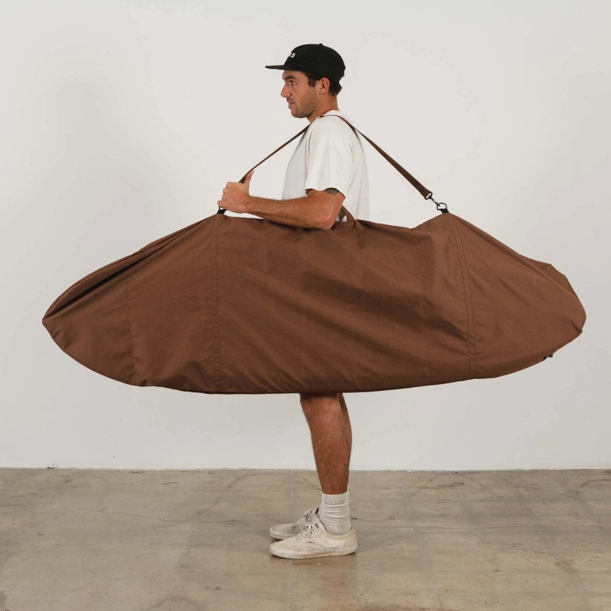 brown canvas surfboard bag