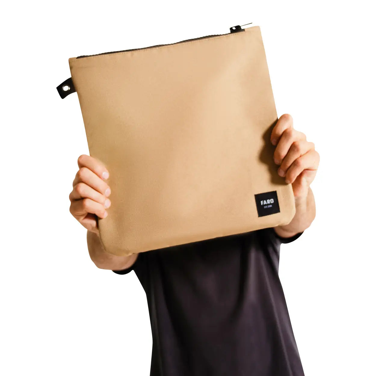 Beige pouch held by a person with 'FARD' branding on a white background
