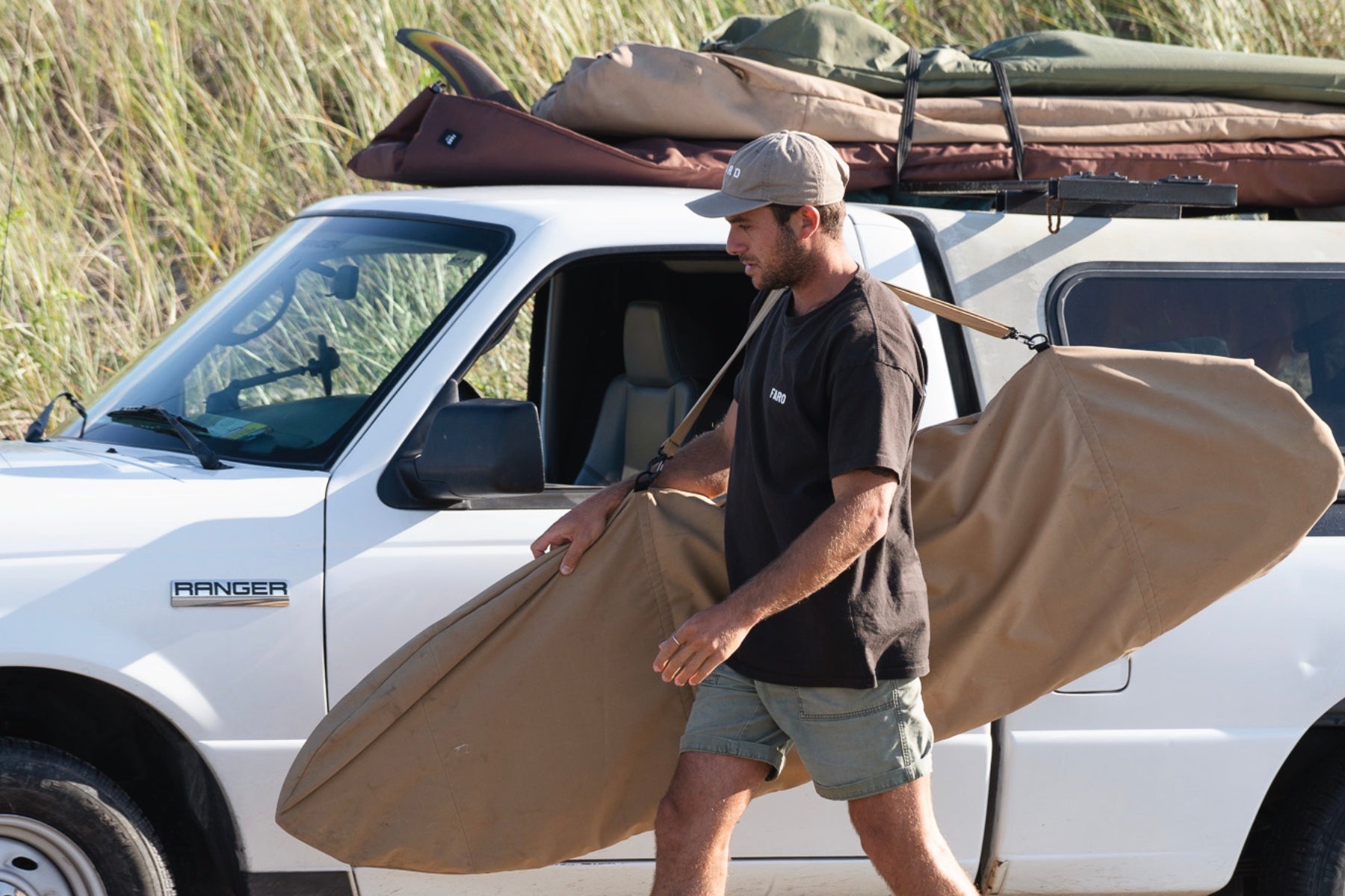 Faro tan surfboad bag going into a truck